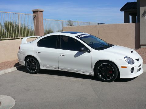 1996 Ford Probe - White Dodge Neon SRT-4 with black wheels and a spoiler is parked in a driveway.