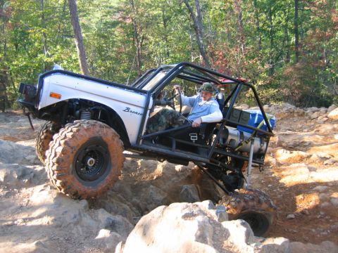 1992 Ford Mustang - This heavily modified Ford Bronco is navigating a challenging rocky trail.