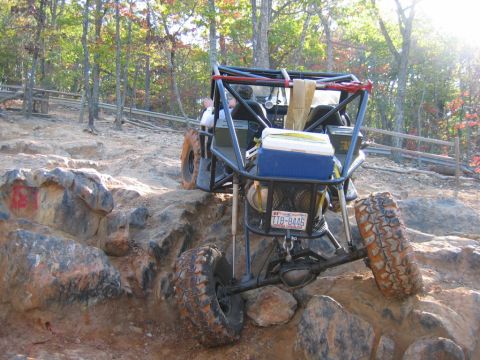 1992 Ford Mustang - This off-road buggy is equipped with a roll cage and large tires, tackling a challenging rocky trail.