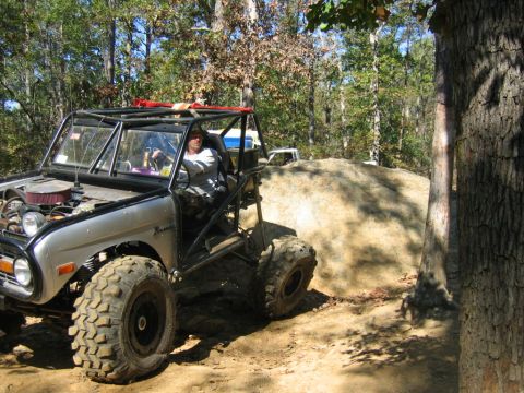 1992 Ford Mustang - A modified silver off-road vehicle navigates a rocky trail with another vehicle visible in the background.