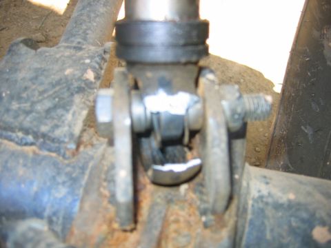 1992 Ford Mustang - A close-up view of a rusty suspension component, showing bolts and metal fatigue.