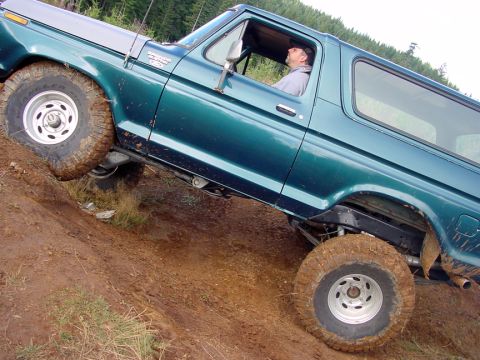 1979 Ford Bronco - This 1979 Ford Bronco navigates a steep, muddy incline, its off-road capabilities.