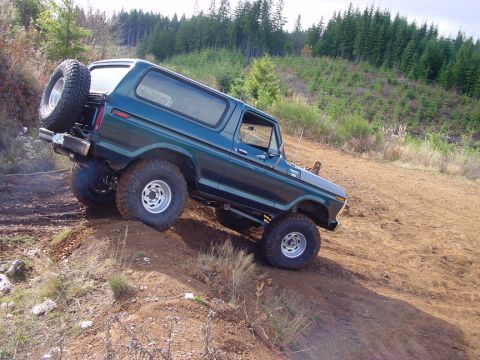 1979 Ford Bronco - This 1979 Ford Bronco navigates a steep, off-road incline with its spare tire prominently displayed on the rear.