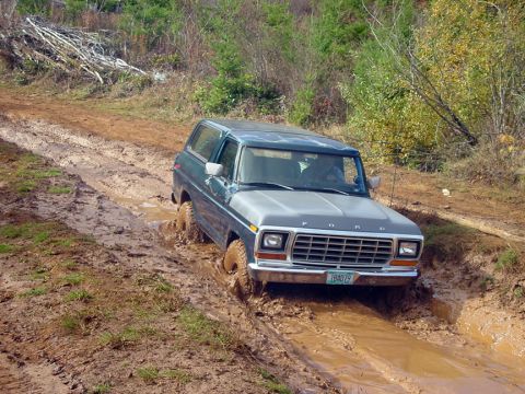 1979 Ford Bronco - 1979 Ford Bronco navigates a challenging muddy off-road path.