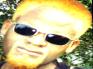 1996 Ford Crown Victoria - A person with distinctive blond hair and sunglasses is shown in this close-up photograph.