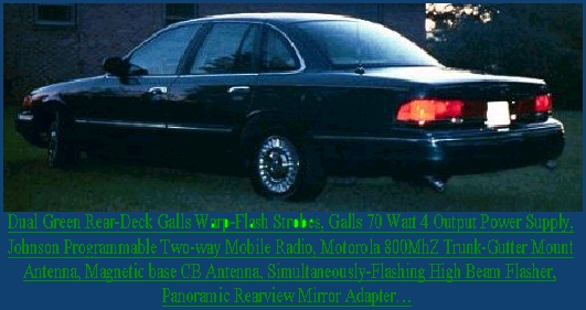 Dark green Ford Crown Victoria sedan, rear 3/4 view with emergency-equipment text overlay