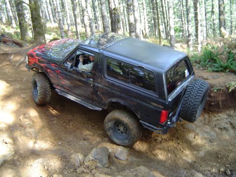 1978 Ford Bronco - Ford Bronco navigates a rocky, wooded trail during an off-road excursion.