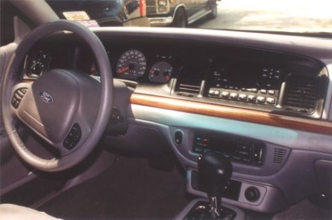 2002 Ford Crown Victoria - The interior of a 2002 Ford Crown Victoria shows the dashboard, steering wheel, and center console.