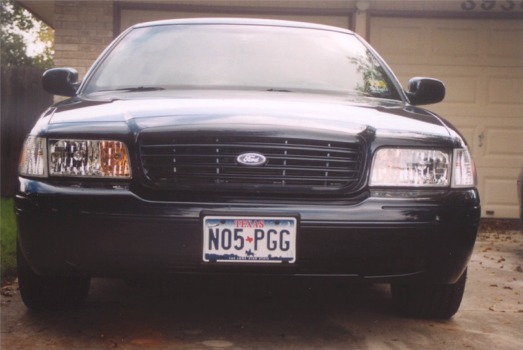 Black 2002 Ford Crown Victoria front view, grille with Ford badge, Texas license plate N05-PGG