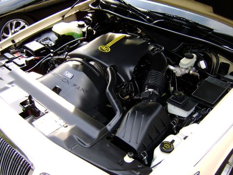 1996 Mercury Grand Marquis - The engine bay of a 1996 Mercury Grand Marquis, the V8 engine and various fluid reservoirs.