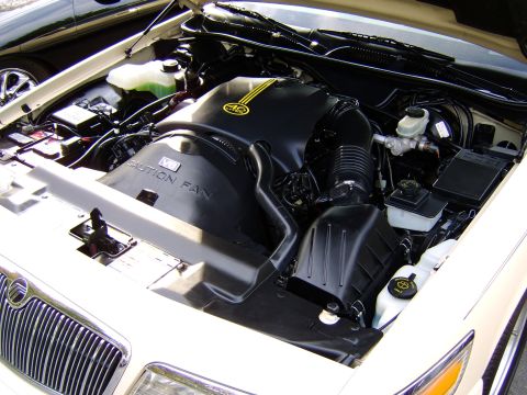 1996 Mercury Grand Marquis - The engine bay of a 1996 Mercury Grand Marquis, a V8 engine and prominent grille detail.