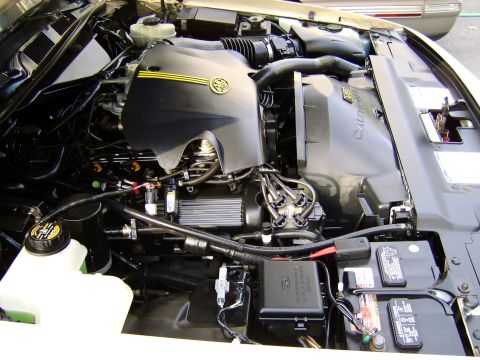 1996 Mercury Grand Marquis - Engine bay detail of a 1996 Mercury Grand Marquis, showing the engine cover and various components.