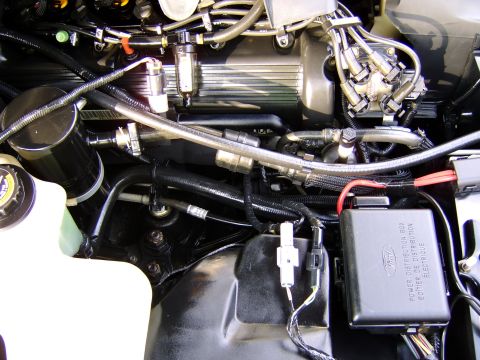1996 Mercury Grand Marquis - Close-up view of a vehicle's engine bay, showing various components and wiring.