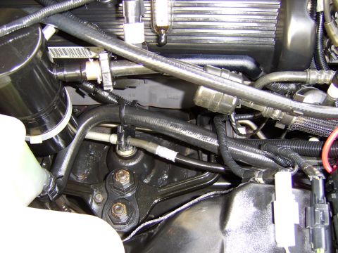 1996 Mercury Grand Marquis - Close-up view of engine bay components, including hoses and wiring harnesses.