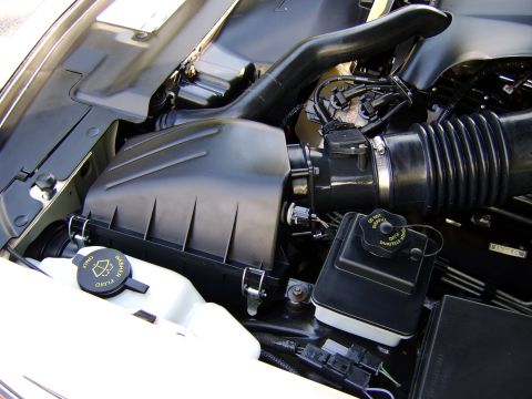 1996 Mercury Grand Marquis - Close-up view of the engine bay, showing the air intake system and various fluid reservoirs.