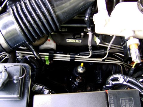 1996 Mercury Grand Marquis - A detailed view of the engine compartment, highlighting various mechanical components and fluid lines.