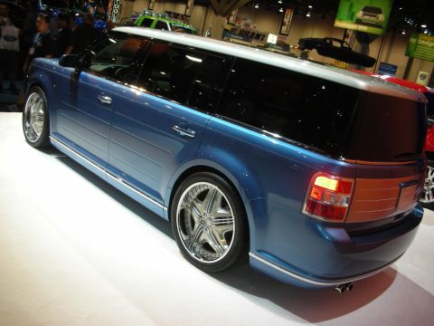 Rear three-quarter of blue Ford Flex crossover on chrome wheels at show