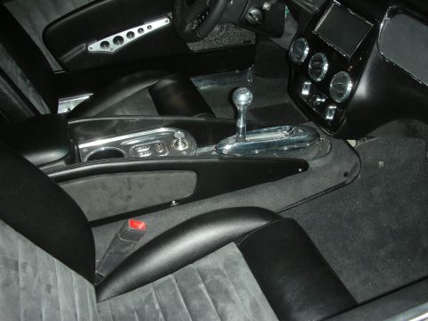 Black custom car interior with chrome shifter, console and suede seats