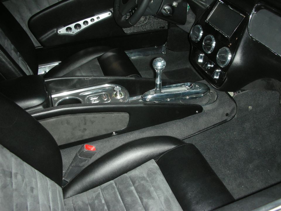 Black custom car interior with chrome shifter, console and suede seats