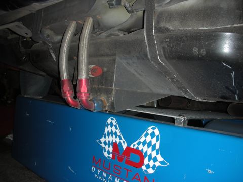 Car undercarriage with braided lines on a Mustang Dynamometer rack