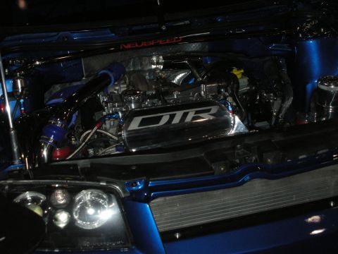 Blue car engine bay with DTR intake plenum and Neuspeed strut bar