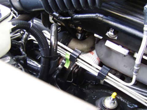 1996 Mercury Grand Marquis - Close-up view of engine components, including various hoses and an oil filter.