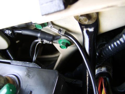 1996 Mercury Grand Marquis - Detail of engine wiring harness with green bolts and black protective sheathing.