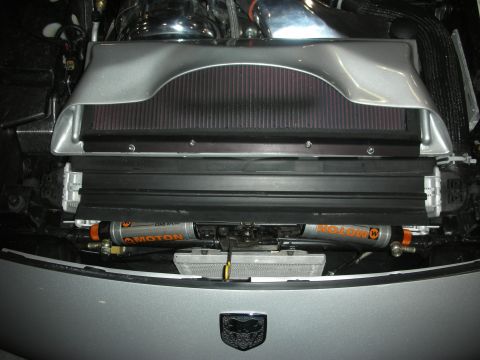 Front of engine bay with twin Moton dampers, radiator, and a winged Dodge logo