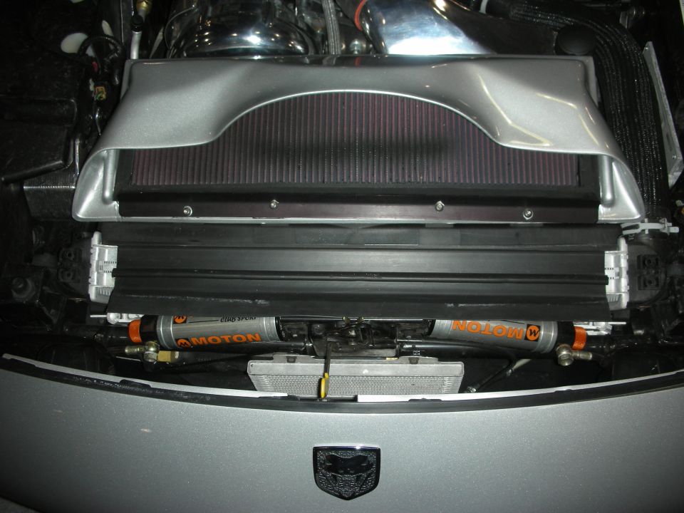 Front of engine bay with twin Moton dampers, radiator, and a winged Dodge logo