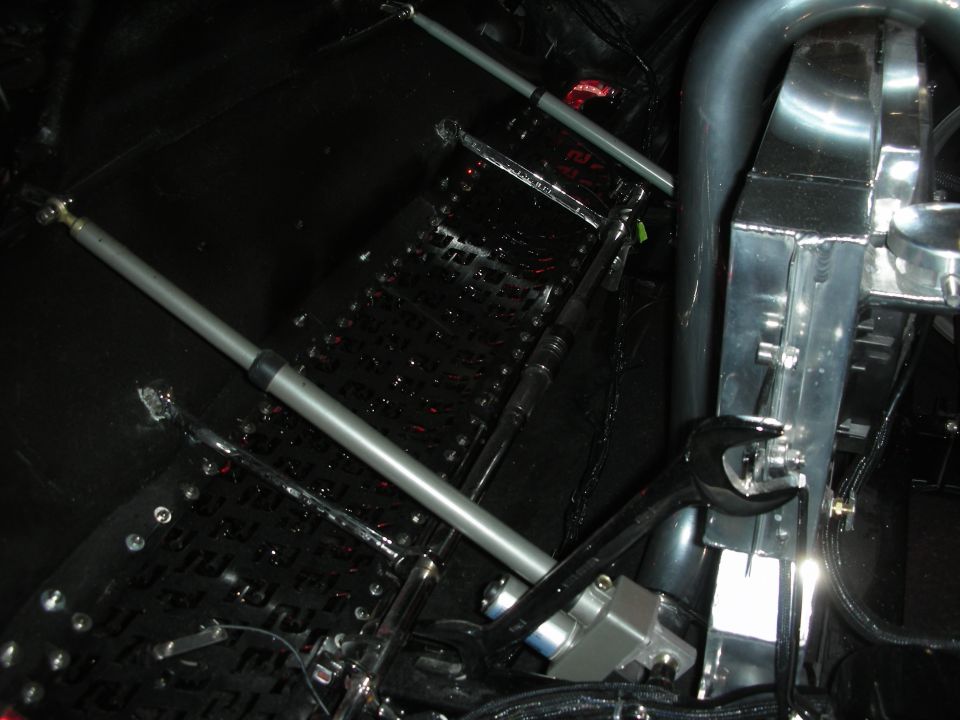 Underside detail of tube-frame chassis with suspension link and diamond plate