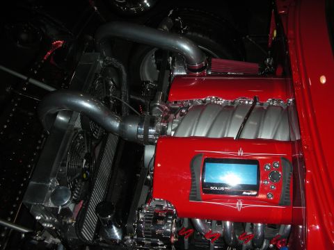 Red V8 engine with intake manifold and mounted Snap-on Solus diagnostic scanner