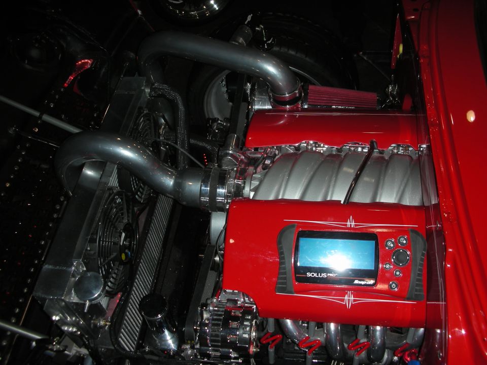 Red V8 engine with intake manifold and mounted Snap-on Solus diagnostic scanner