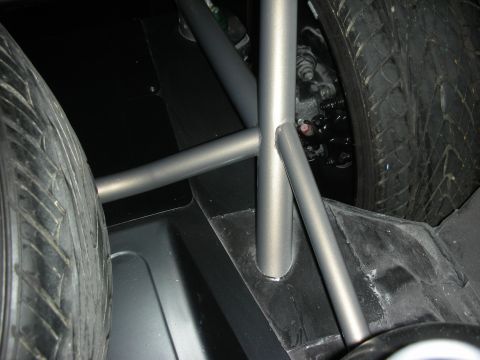 Tube-frame chassis crossmember between two tires in custom car underbody