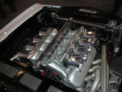 Polished V8 engine with individual throttle-body intake stacks in show car