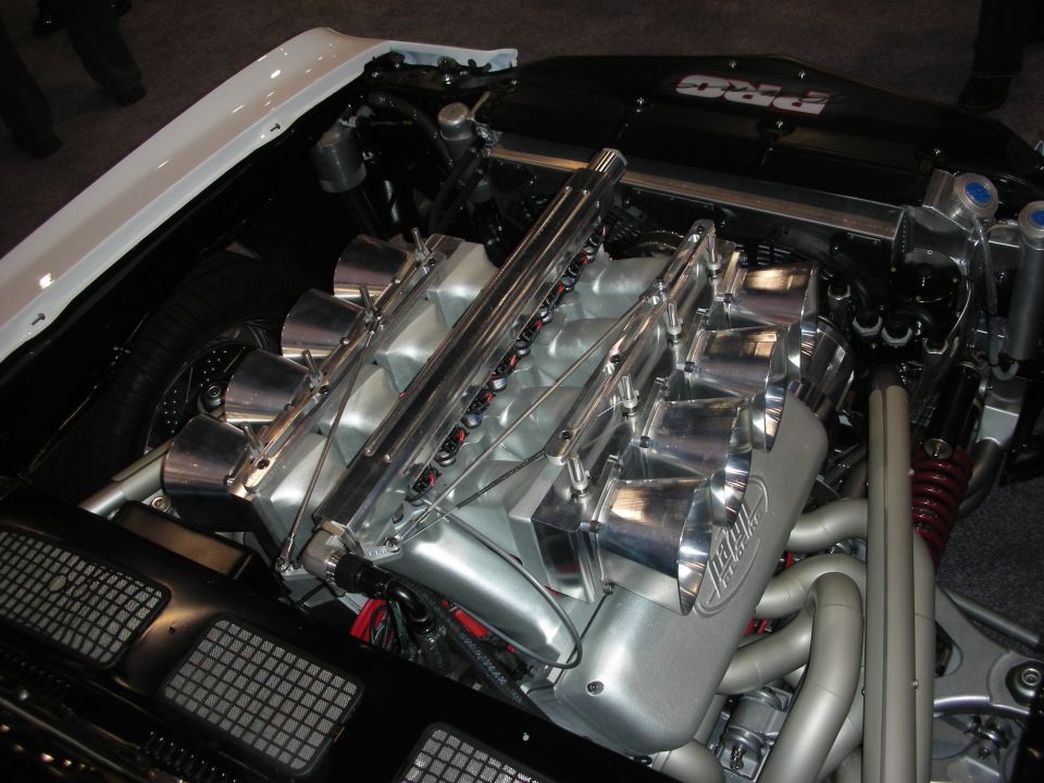Polished V8 engine with individual throttle-body intake stacks in show car