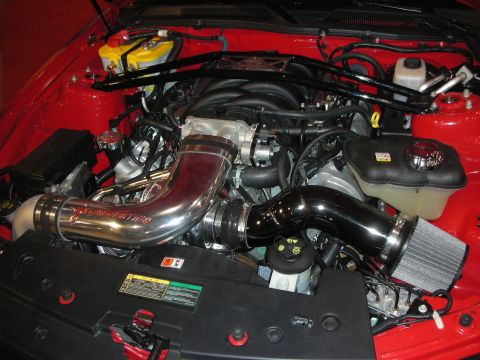 1998 Ford Crown Victoria - modern fuel-injected engine bay with a polished and black chrome cold-air intake routed through a red-painted car.