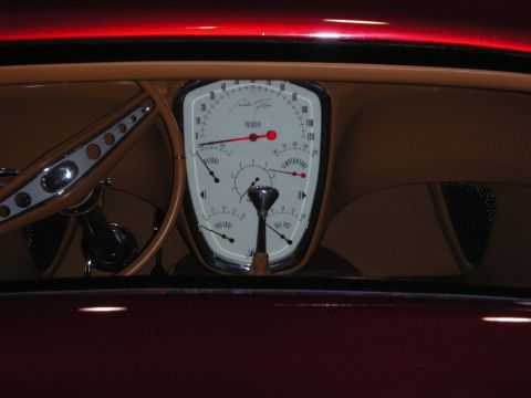 1998 Ford Crown Victoria - custom car dashboard viewed through the windshield, with an oval white gauge cluster and a drilled banjo steering wheel.