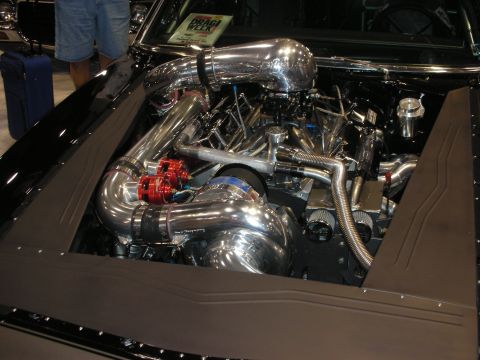 1998 Ford Crown Victoria - Highly polished engine bay with chromed intake piping, red AN fittings and braided lines mounted in a black show car.