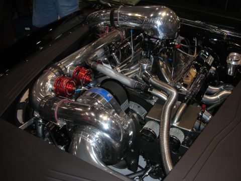 1998 Ford Crown Victoria - mirror-polished forced-induction engine bay packed with chrome piping, a turbo and red anodized fuel components.