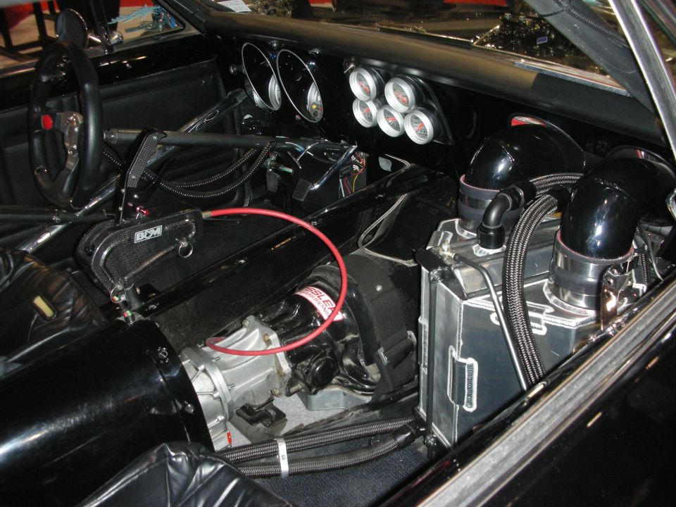 Stripped race-car interior with steering wheel, gauges and chrome turbos