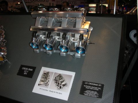 1998 Ford Crown Victoria - polished LS1 cross-ram fuel-injection intake with eight individual throttle bodies mounted on a display board with spec cards.