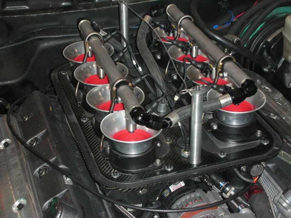 Detail of carbon-fiber tray with red velocity stacks and steel fuel rails