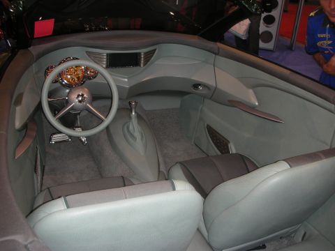 1998 Ford Crown Victoria - sculpted custom interior in pale gray leather with a polished three-spoke billet steering wheel and smooth molded dashboard.