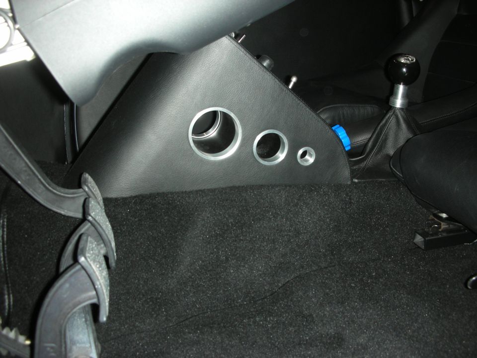 Custom black interior panel with three round vents and a shift boot
