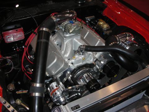 1998 Ford Crown Victoria - red car's engine bay holds a supercharged V8 with a carburetor, black intercooler piping and MSD ignition components.