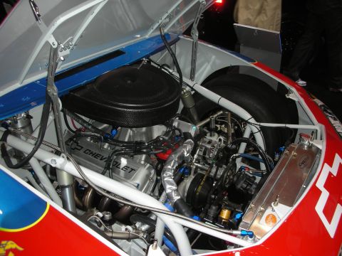 1998 Ford Crown Victoria - Chevrolet V8 engine with a round carbon airbox and roll-cage tubing fills the bay of a red, white and blue tube-frame race car.