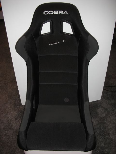 1998 Ford Crown Victoria - black fabric Cobra racing bucket seat with an embroidered logo on the headrest, photographed upright against a white backdrop.