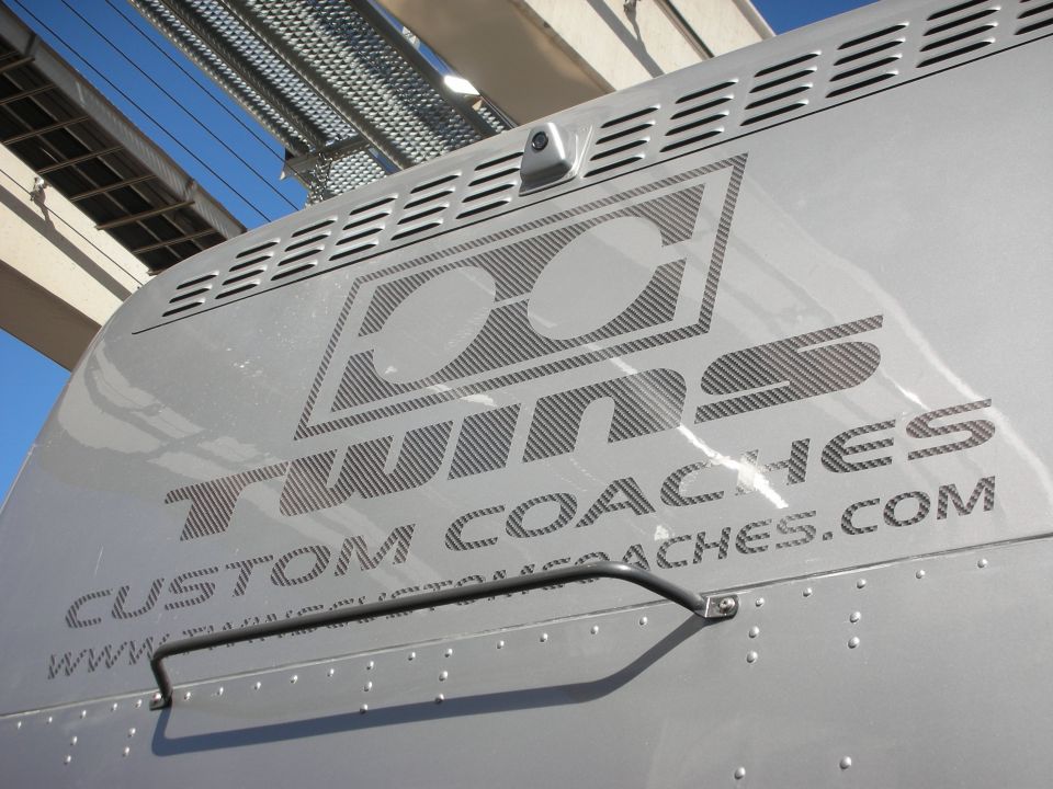 Silver coach panel with DC Twins Custom Coaches logo and website text