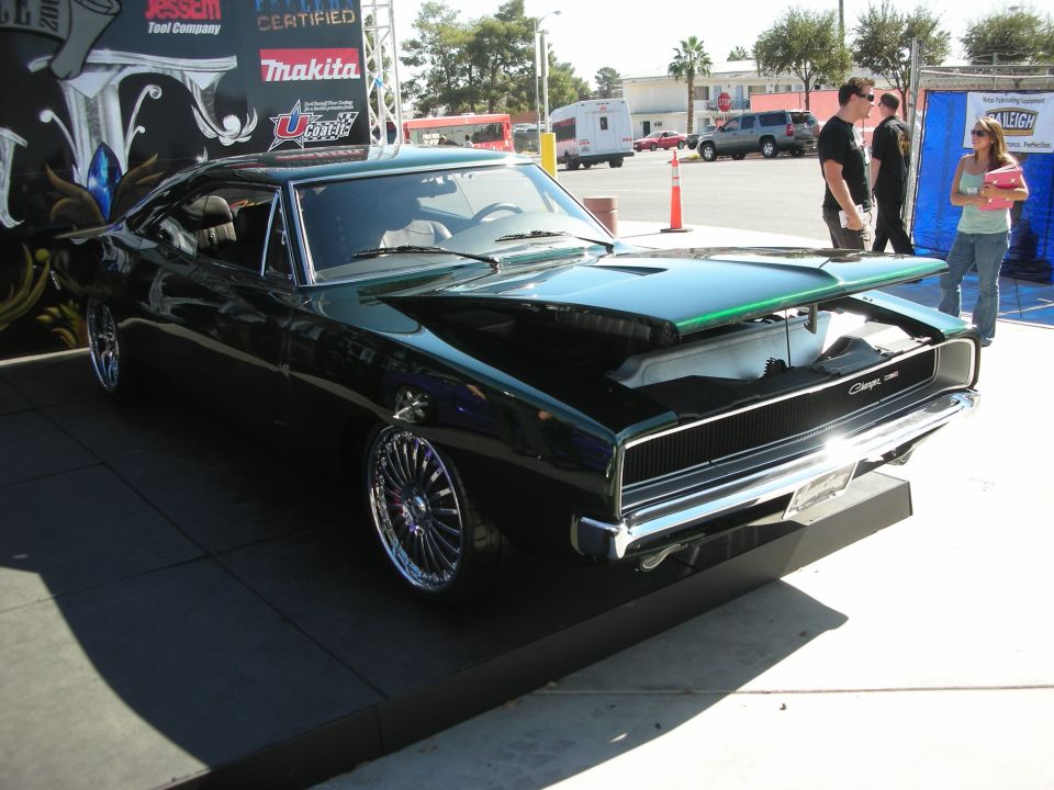 Black custom Dodge Charger muscle car on display in an outdoor parking lot