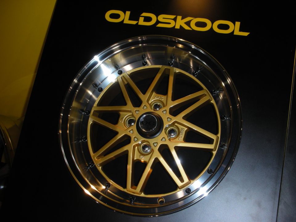 Gold Old Skool brand wheel mounted on a black display board